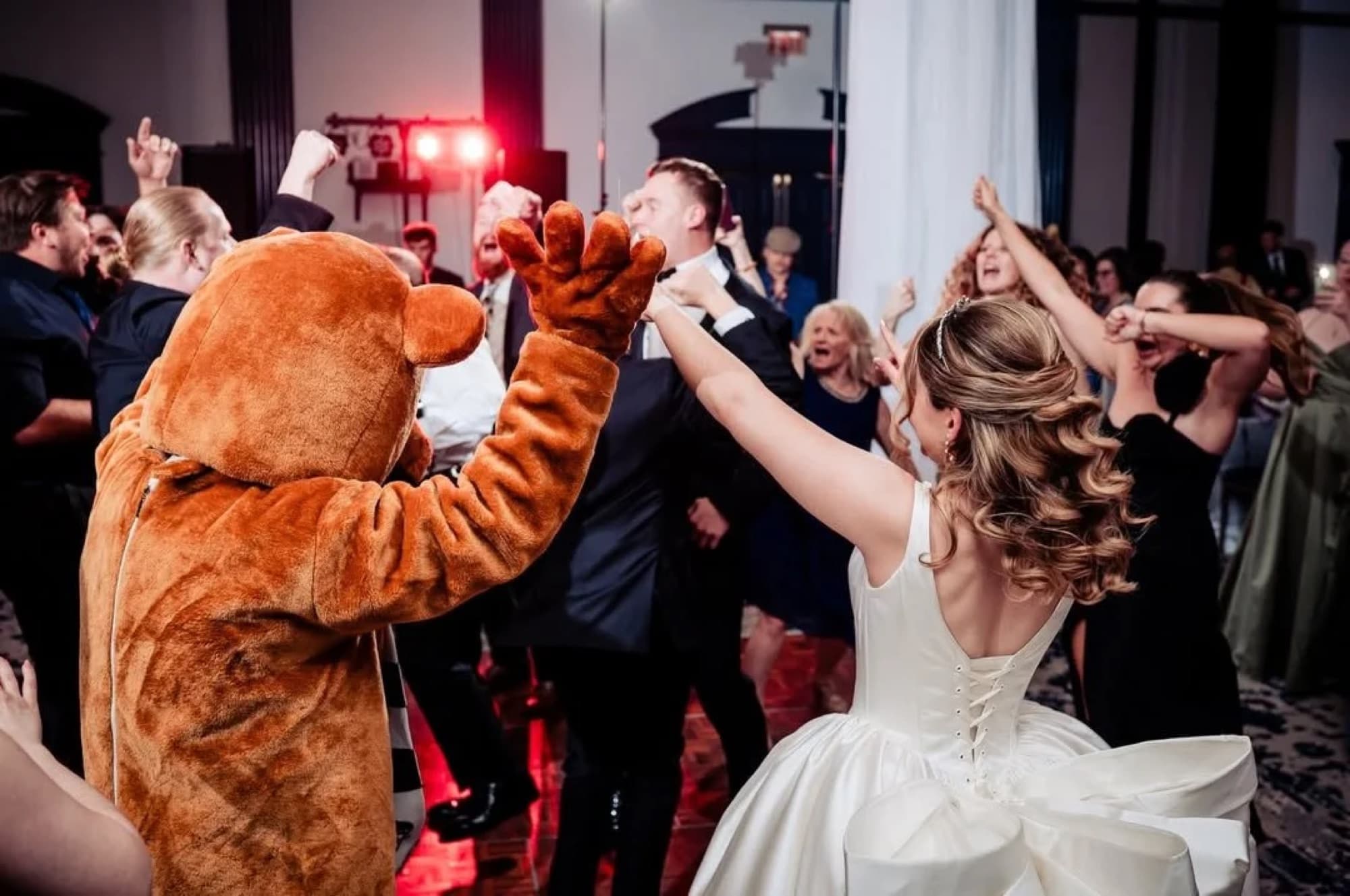 The Nittany Lion dancing with a bride at a Penn State wedding